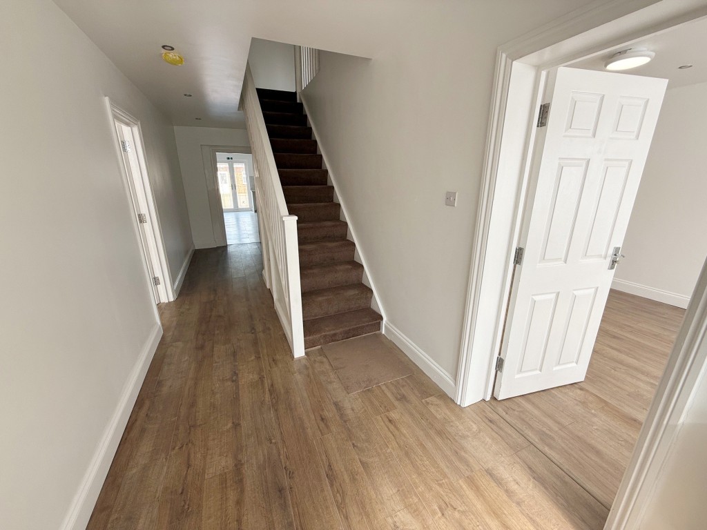 Lot: 166 - HOUSE WITH VERSATILE ACCOMMODATION - Hallway with stairs leading to first floor and doors to ground floor accommodation